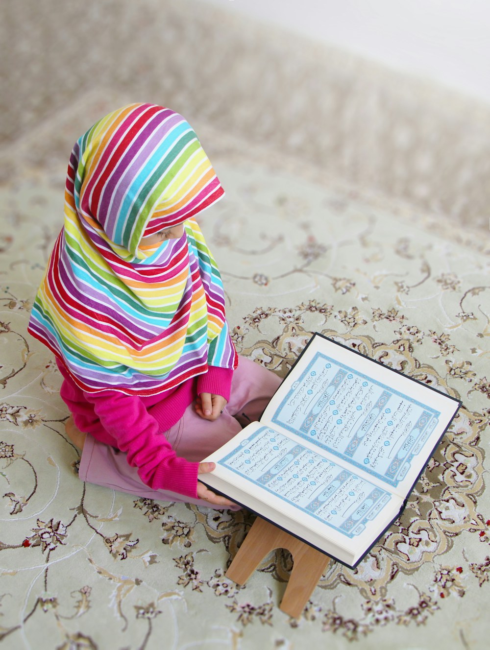 Young Muslim girl reading the Quran — online Quran classes for kids